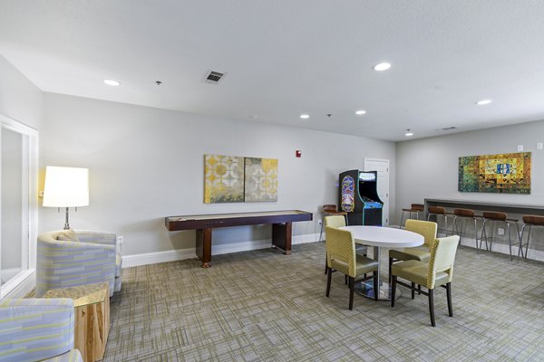 Clubhouse game room with pool table and seating at Timberlinks at Denton Apartments, ideal for resident gatherings and leisure activities