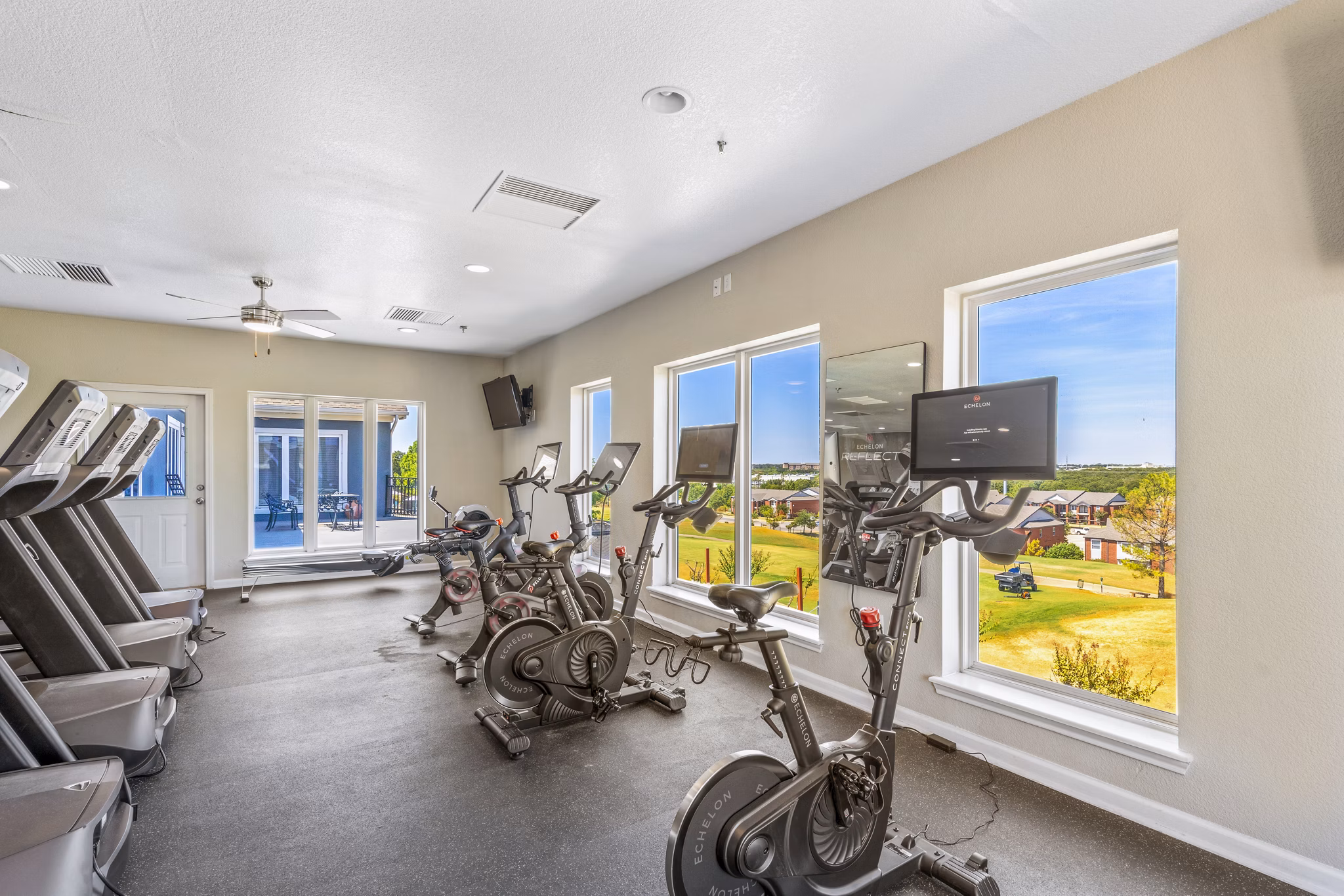 Modern fitness center with cardio and weight equipment at Timberlinks at Denton Apartments for active living