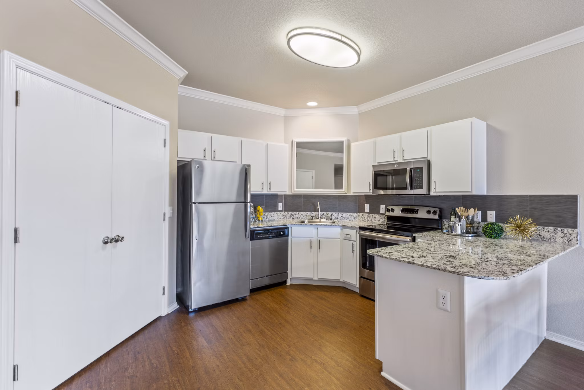 Modern kitchen with stainless steel appliances at Timberlinks at Denton Homes luxury apartments