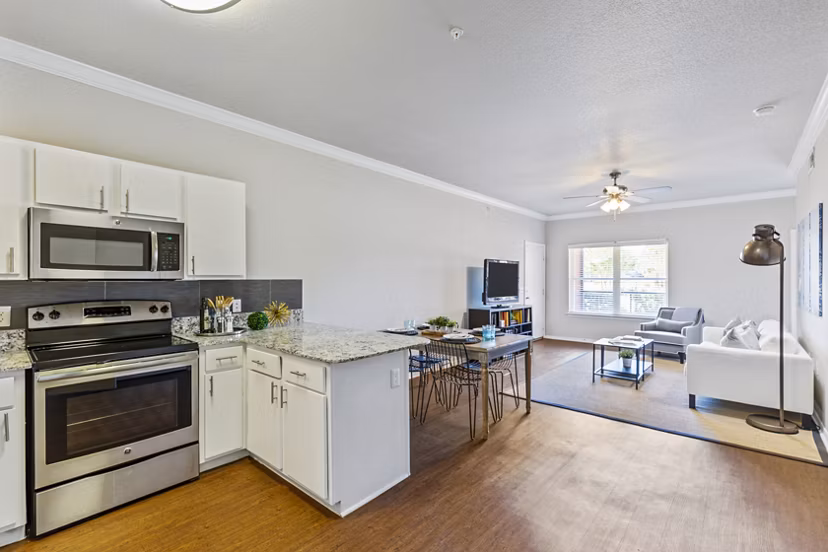Modern kitchen with stainless steel appliances in Timberlinks at Denton Homes, Greystar luxury apartments