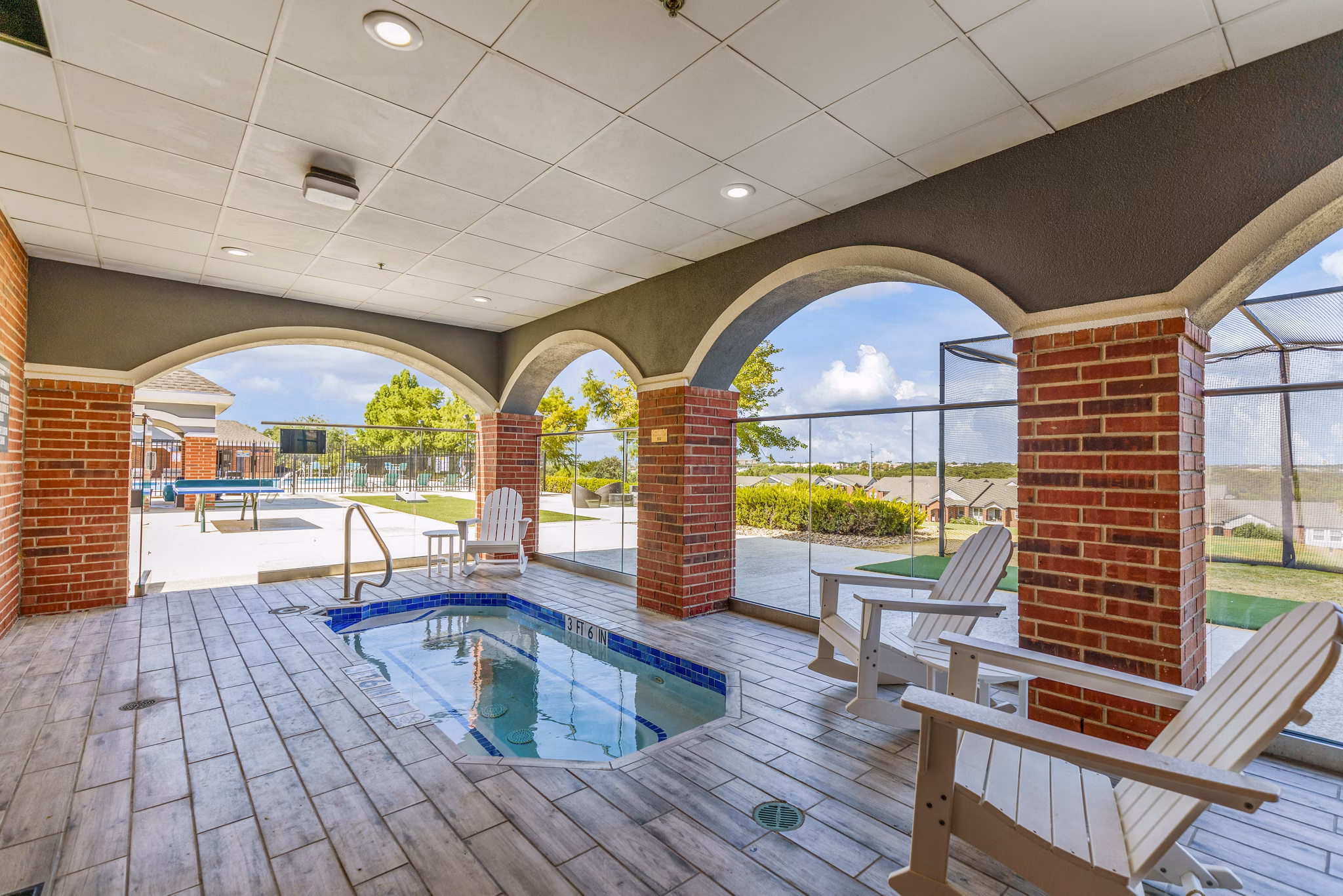 Hot tub retreat at Timberlinks at Denton Apartments featuring relaxing Jacuzzi amenities for leisure and comfort