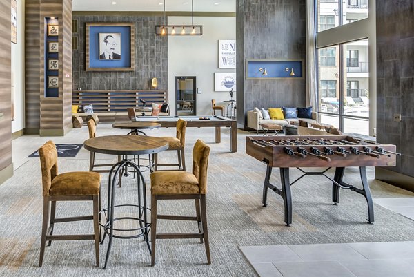 Game room featuring modern arcade games and pool table at One Riverwalk Apartments