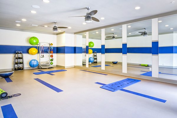 One Riverwalk Apartments: State-of-the-art fitness center with modern equipment