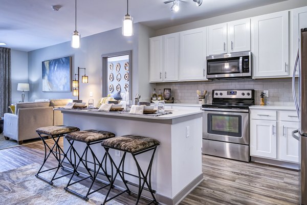 Dining room with elegant furniture and modern lighting at One Riverwalk Apartments
