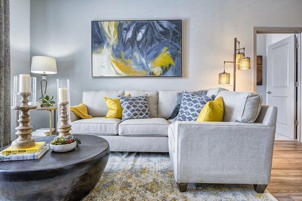 Luxurious living room with sleek furnishings at One Riverwalk Apartments, featuring large windows and modern decor for maximum comfort