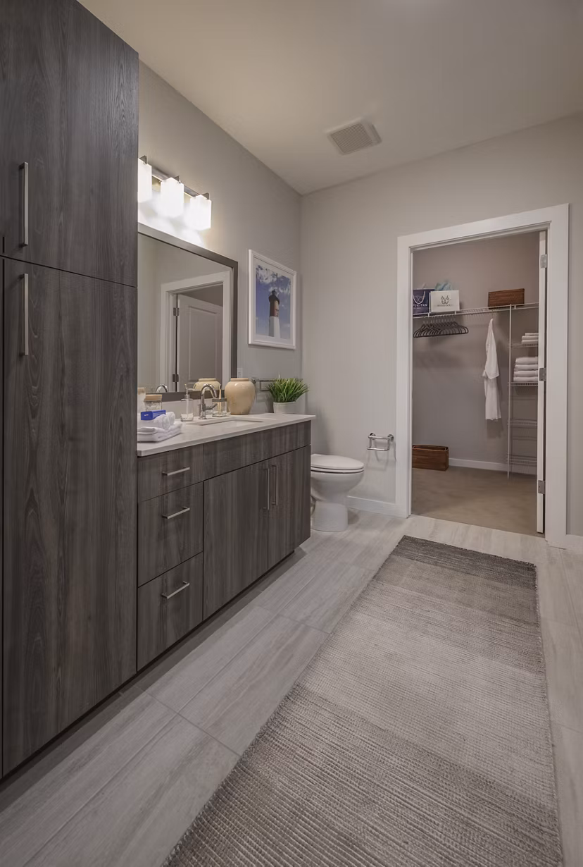 Elegant bathroom featuring marble countertops and spacious walk-in shower at Everleigh Cape Cod apartments