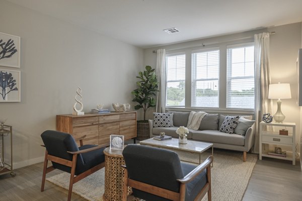 Spacious living room with elegant decor and natural light in Everleigh Cape Cod luxury apartments
