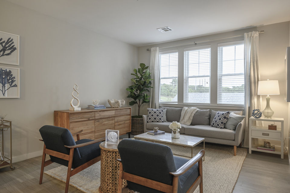 Spacious living room with elegant decor and natural light in Everleigh Cape Cod luxury apartments