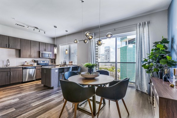 Dining room featuring contemporary decor and elegant lighting at Miro Apartments, luxury living by Greystar