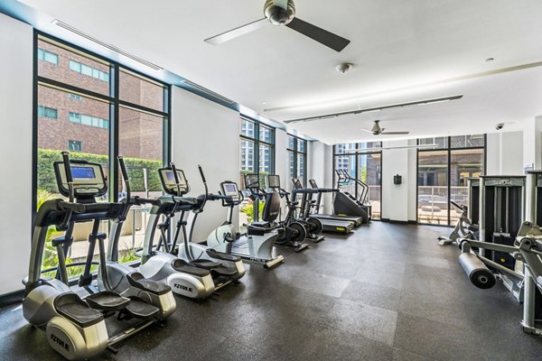 Miro Apartments: state-of-the-art fitness center with modern equipment and bright lighting for active living