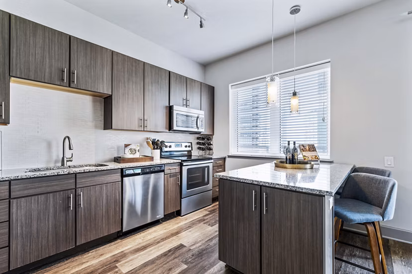 Modern kitchen with stainless steel appliances in Miro Apartments