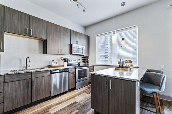 Modern kitchen with stainless steel appliances in Miro Apartments