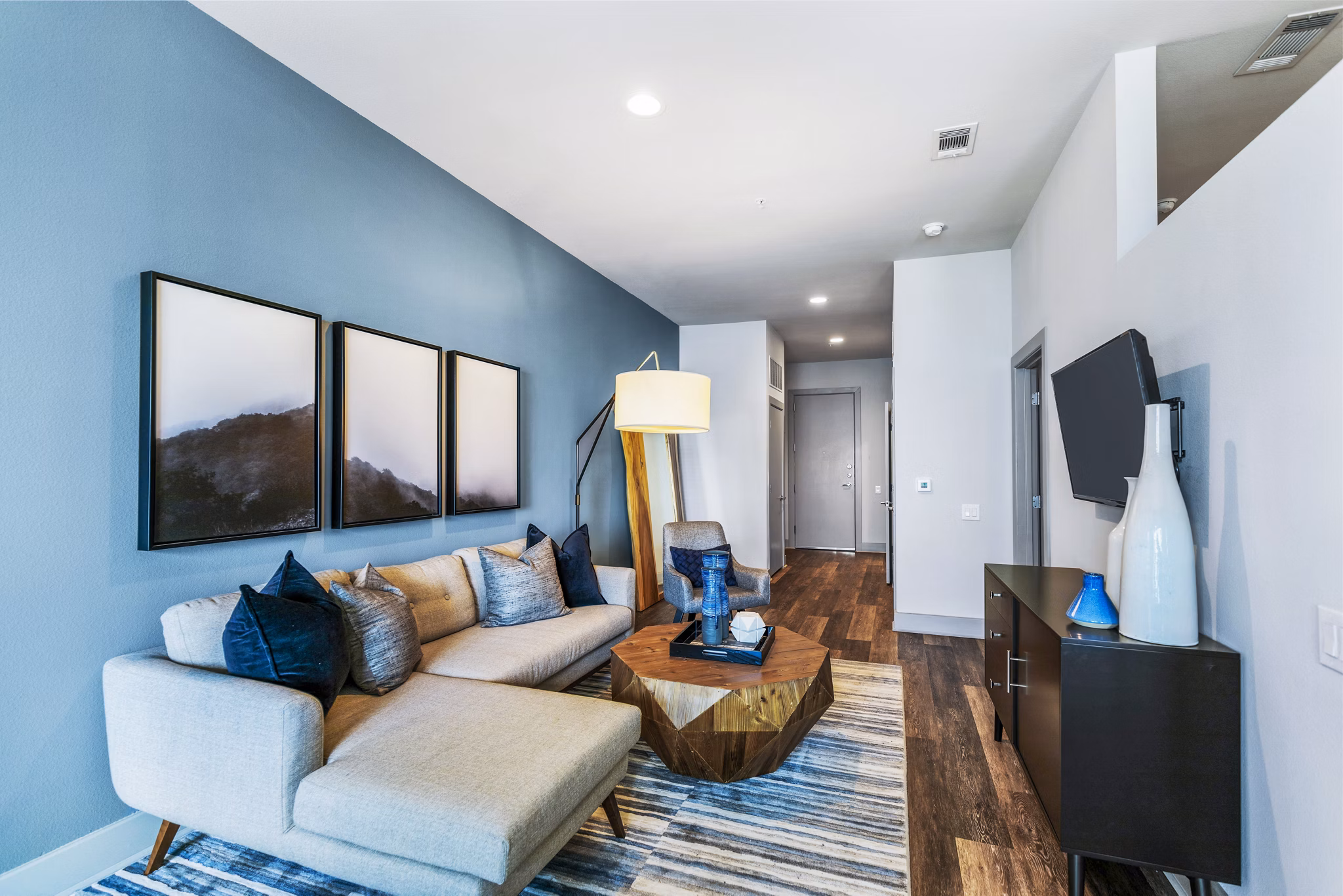 Modern living room with sleek furniture and large windows at Miro Apartments