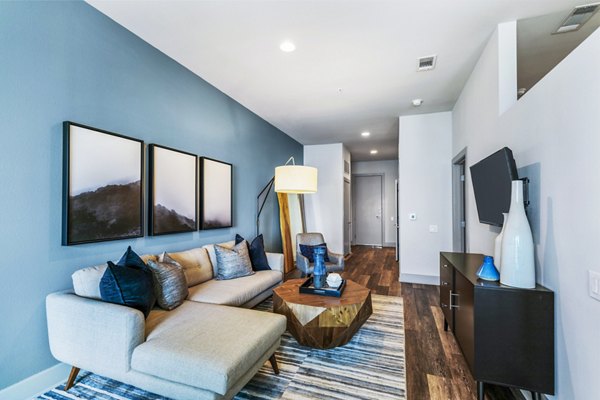 Modern living room with sleek furniture and large windows at Miro Apartments