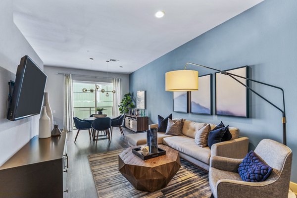 Spacious living room with modern furnishings and natural lighting at Miro Apartments Perfect for relaxation in an upscale setting