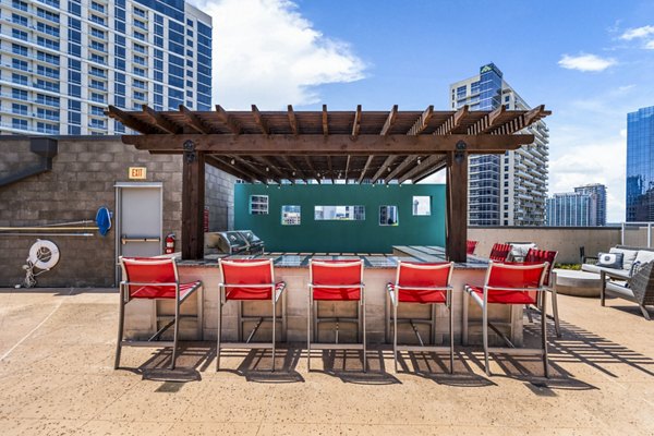 Outdoor grill area with modern patio furniture at Miro Apartments, offering luxury living in prime locations