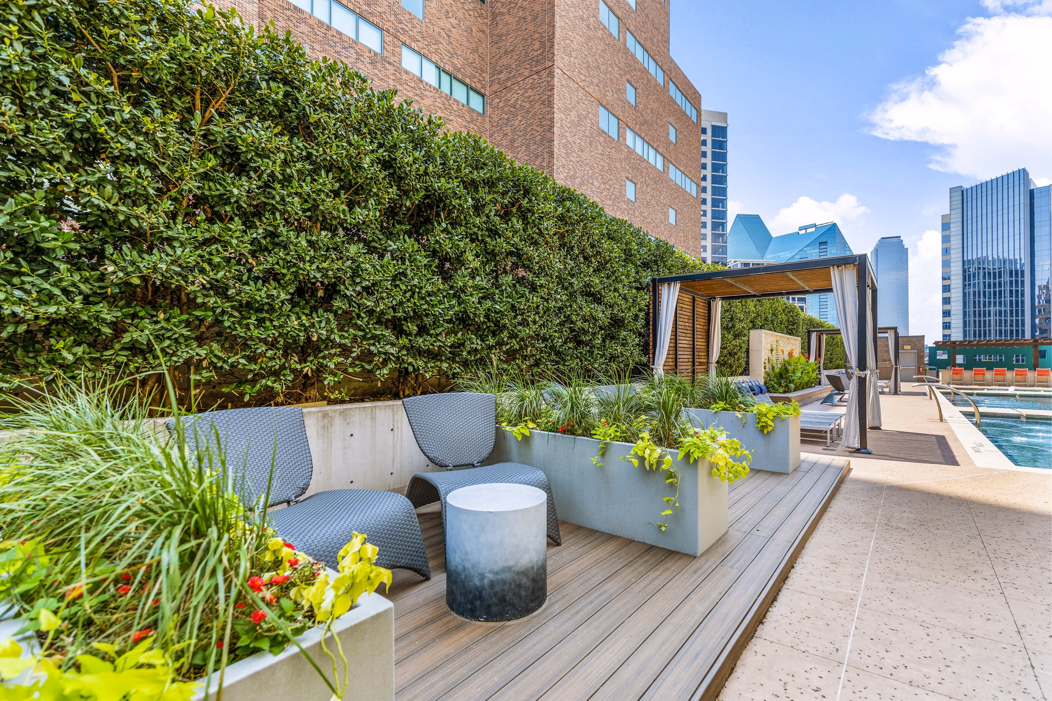 Luxury pool patio with stylish seating at Miro Apartments, offering relaxation in a premium residential setting