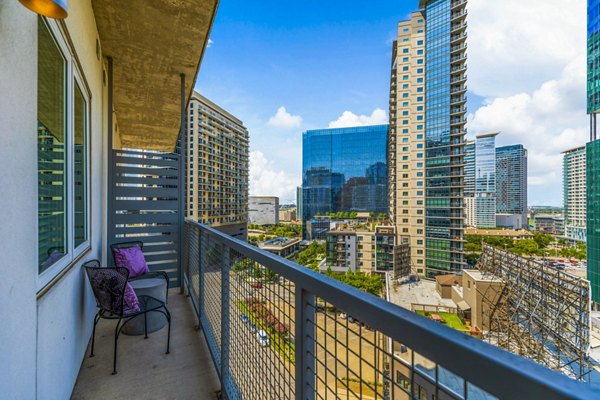 Cozy patio with modern furniture and lush plants at Miro Apartments, perfect for relaxation and outdoor dining in this luxury community