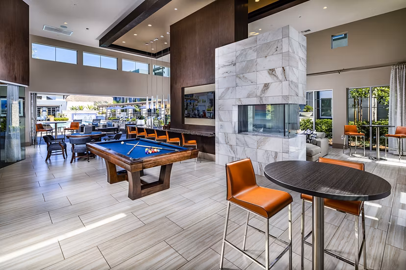 Game room with pool table and arcade games at Core at Sycamore Highlands apartments