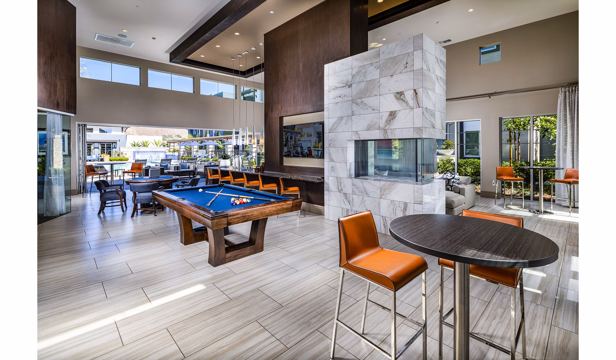 Game room with pool table and arcade games at Core at Sycamore Highlands apartments