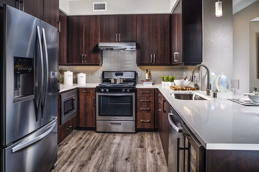 Modern kitchen with stainless steel appliances at Core at Sycamore Highlands luxury apartments