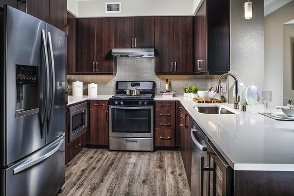 Modern kitchen with stainless steel appliances at Core at Sycamore Highlands luxury apartments
