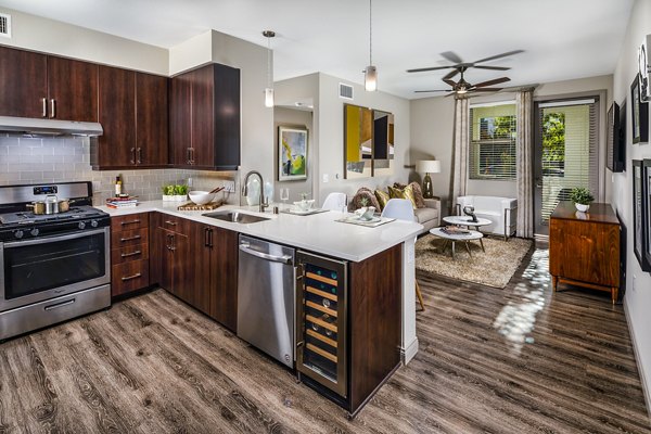 Modern kitchen featuring stainless steel appliances at Core at Sycamore Highlands luxury apartments