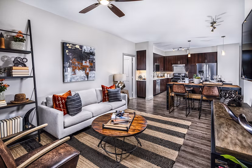 Spacious living room with modern decor and large windows at Core at Sycamore Highlands, luxury apartments