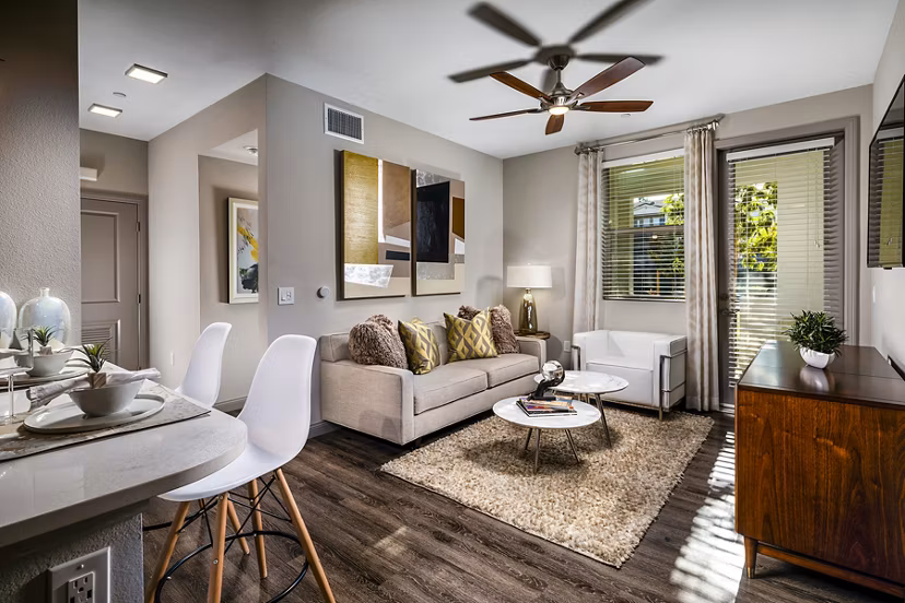 Modern living room with stylish furnishings at Core at Sycamore Highlands, featuring cozy seating and ample natural light