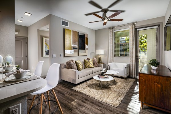 Modern living room with stylish furnishings at Core at Sycamore Highlands, featuring cozy seating and ample natural light
