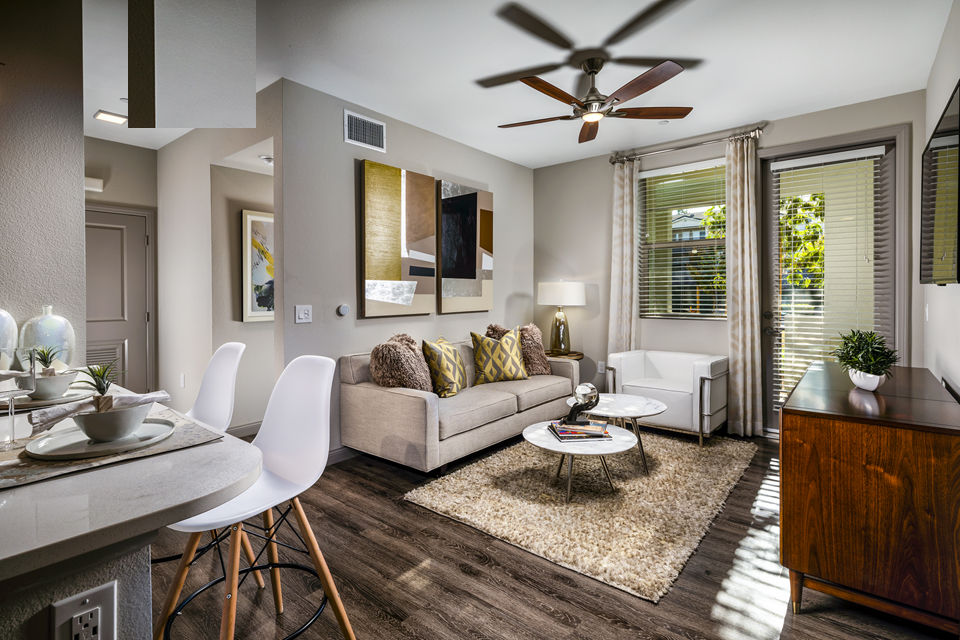 Modern living room with stylish furnishings at Core at Sycamore Highlands, featuring cozy seating and ample natural light