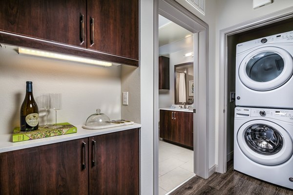 Modern laundry room with front-load washers and dryers at Core at Sycamore Highlands apartments
