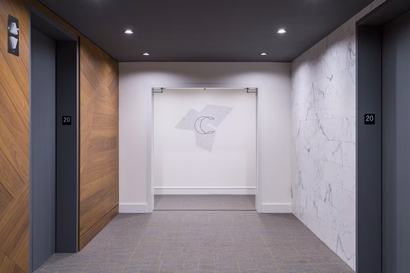 Hallway with modern elevator doors at Circa LA Apartments in luxury Greystar community
