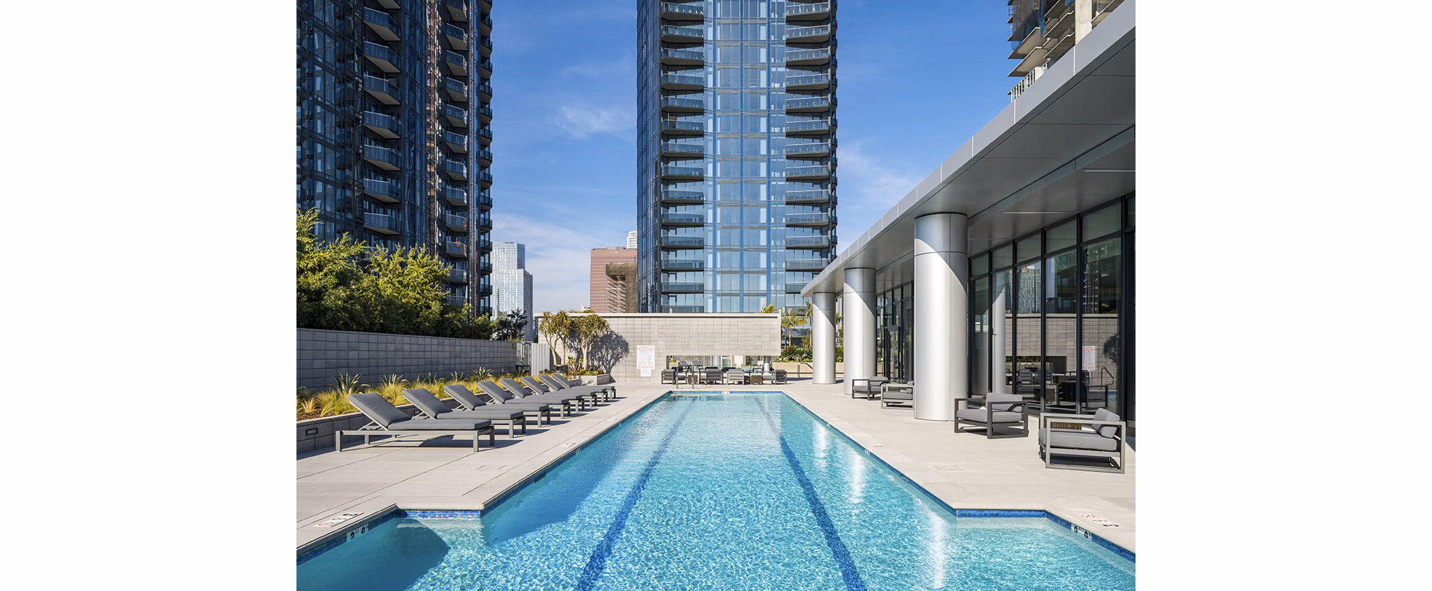 Resort-style pool with lounge chairs at Circa LA Apartments, offering luxury living