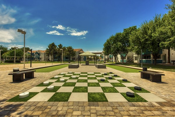 Galleria Palms: Tranquil courtyard with lush greenery and seating in luxury apartments