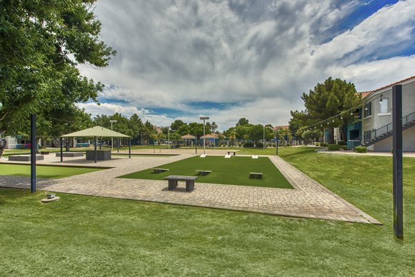 Serene courtyard with lush greenery and seating at Galleria Palms Apartments