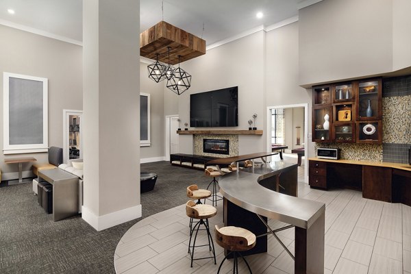 Clubhouse featuring modern fitness center and lounge area at The Standard at Athens Apartments