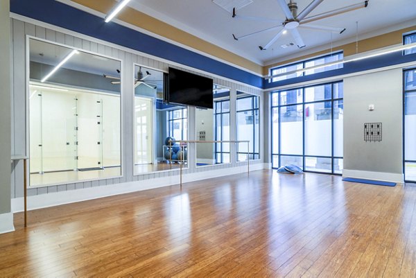 Yoga studio with mirrored walls and natural lighting at The Standard Apartments