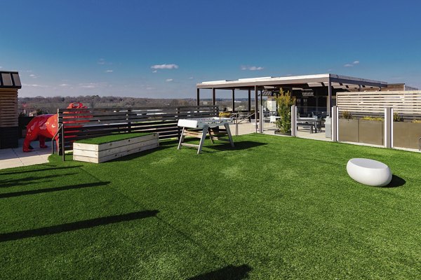 The Standard at Athens: Modern courtyard with lush greenery and seating areas in a luxury apartment community