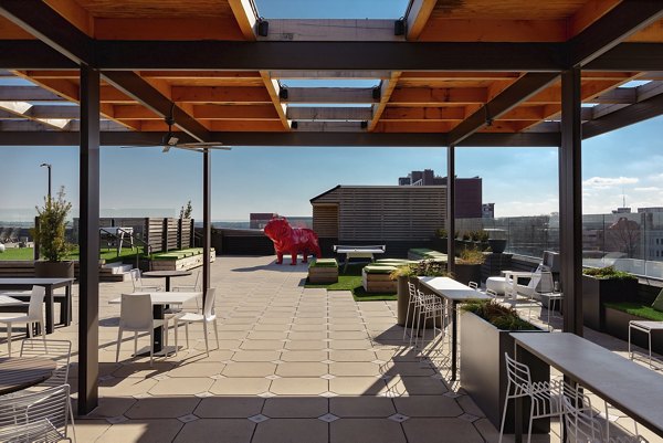 Inviting courtyard with lush greenery and seating areas at The Standard at Athens Apartments