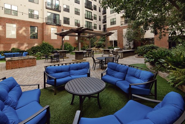 The Standard at Athens: Serene courtyard with lush greenery and seating areas