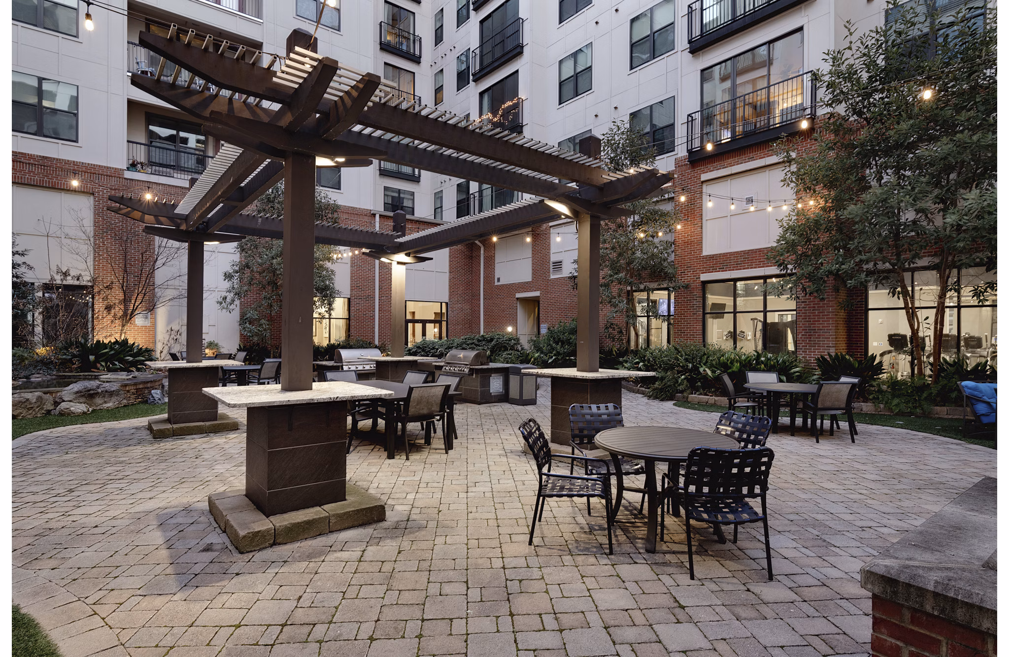 Outdoor grill area with seating at The Standard at Athens Apartments