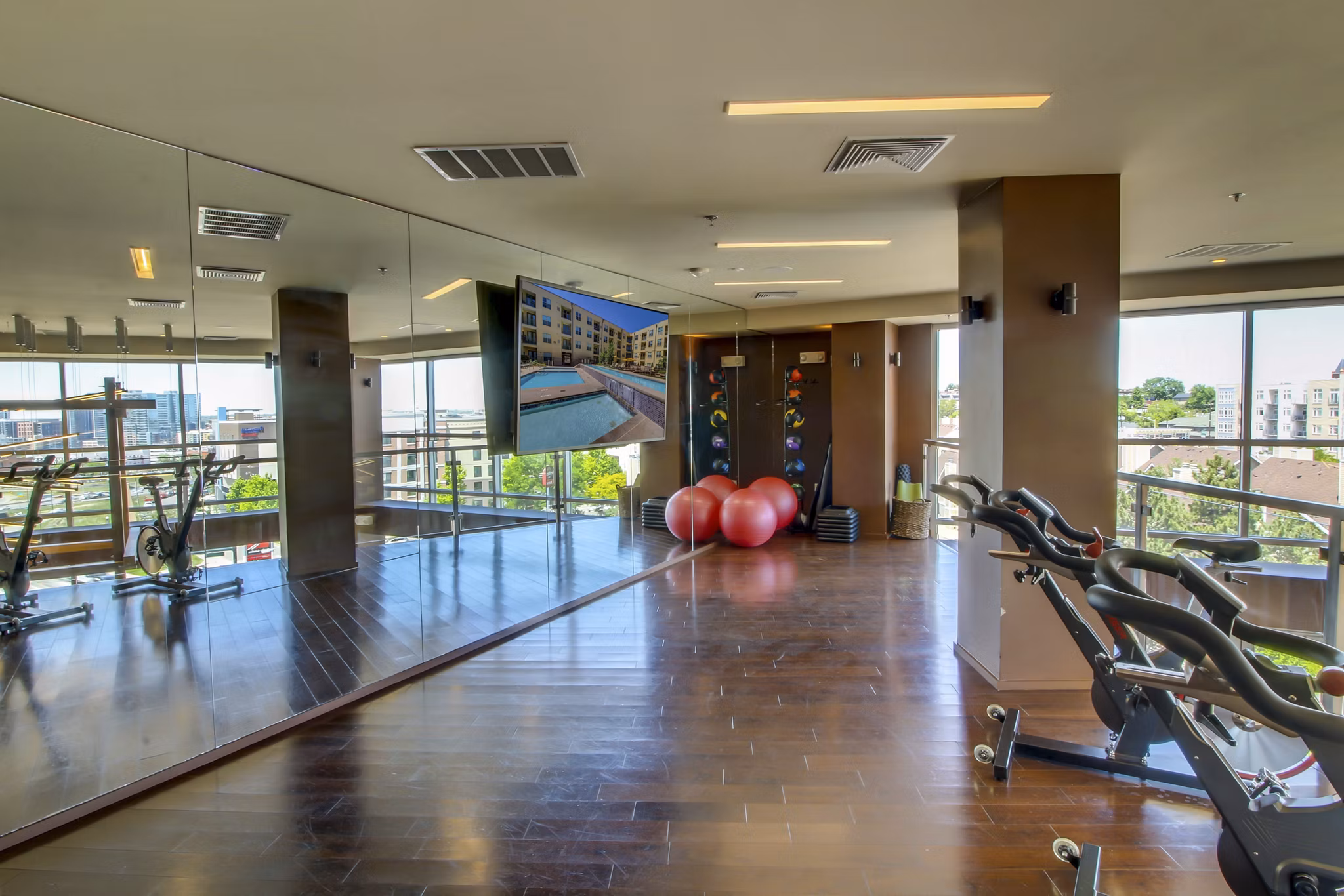 Modern yoga/spin studio with natural lighting at 2785 Speer Apartments for fitness enthusiasts