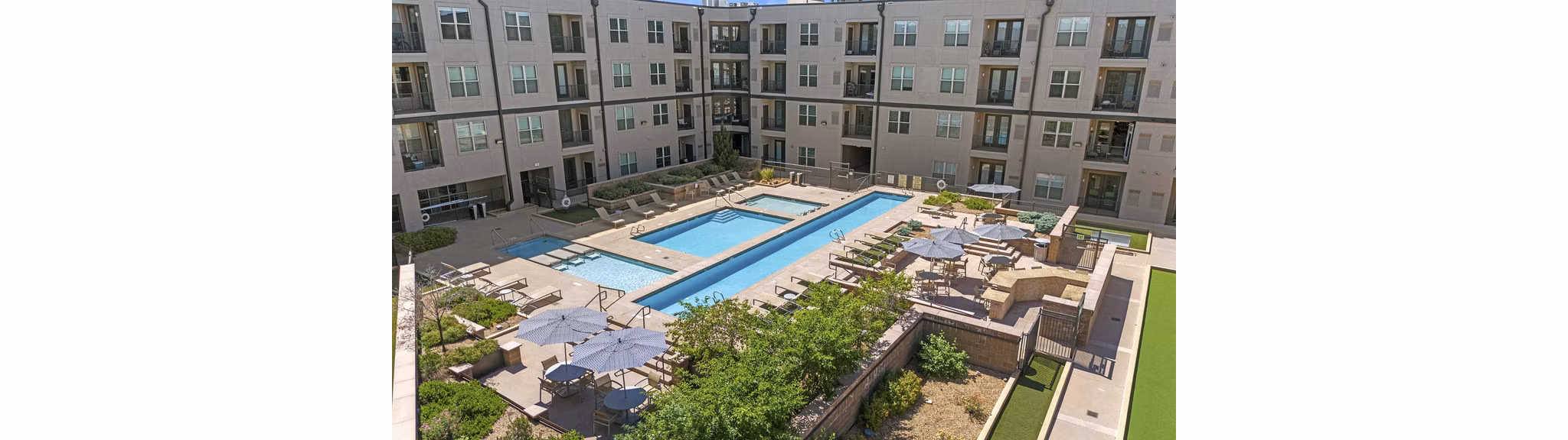 Sparkling outdoor pool with lounge seating at 2785 Speer Apartments in vibrant Denver neighborhood