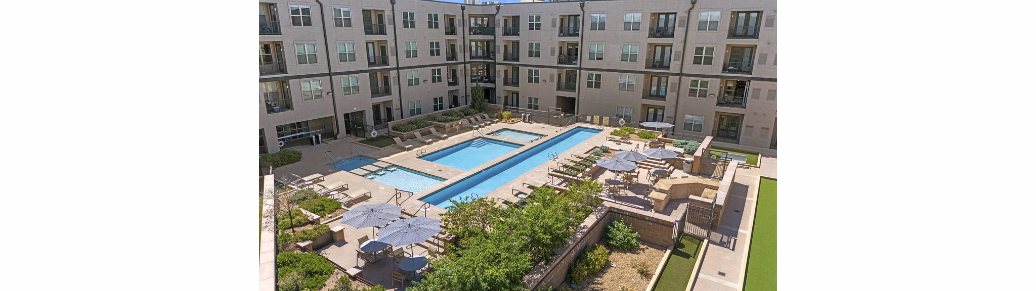 Sparkling outdoor pool with lounge seating at 2785 Speer Apartments in vibrant Denver neighborhood
