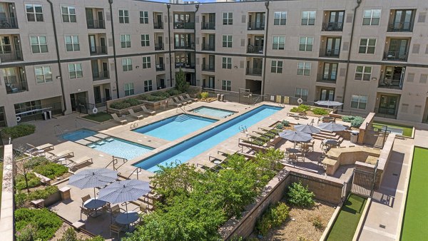 Sparkling outdoor pool with lounge seating at 2785 Speer Apartments in vibrant Denver neighborhood