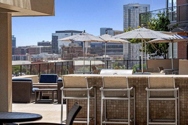 Rooftop deck with seating and skyline views at 2785 Speer Apartments