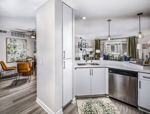 Kitchen featuring modern appliances and sleek countertops at Artisan Laguna Beach Apartments