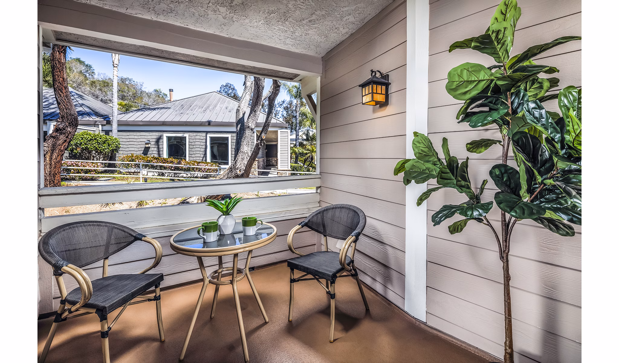 Stylish outdoor patio with modern seating at Artisan Laguna Beach Apartments, ideal for relaxing under sunny skies
