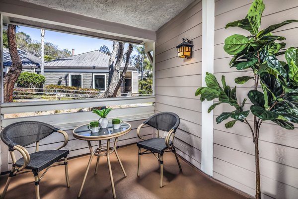 Stylish outdoor patio with modern seating at Artisan Laguna Beach Apartments, ideal for relaxing under sunny skies
